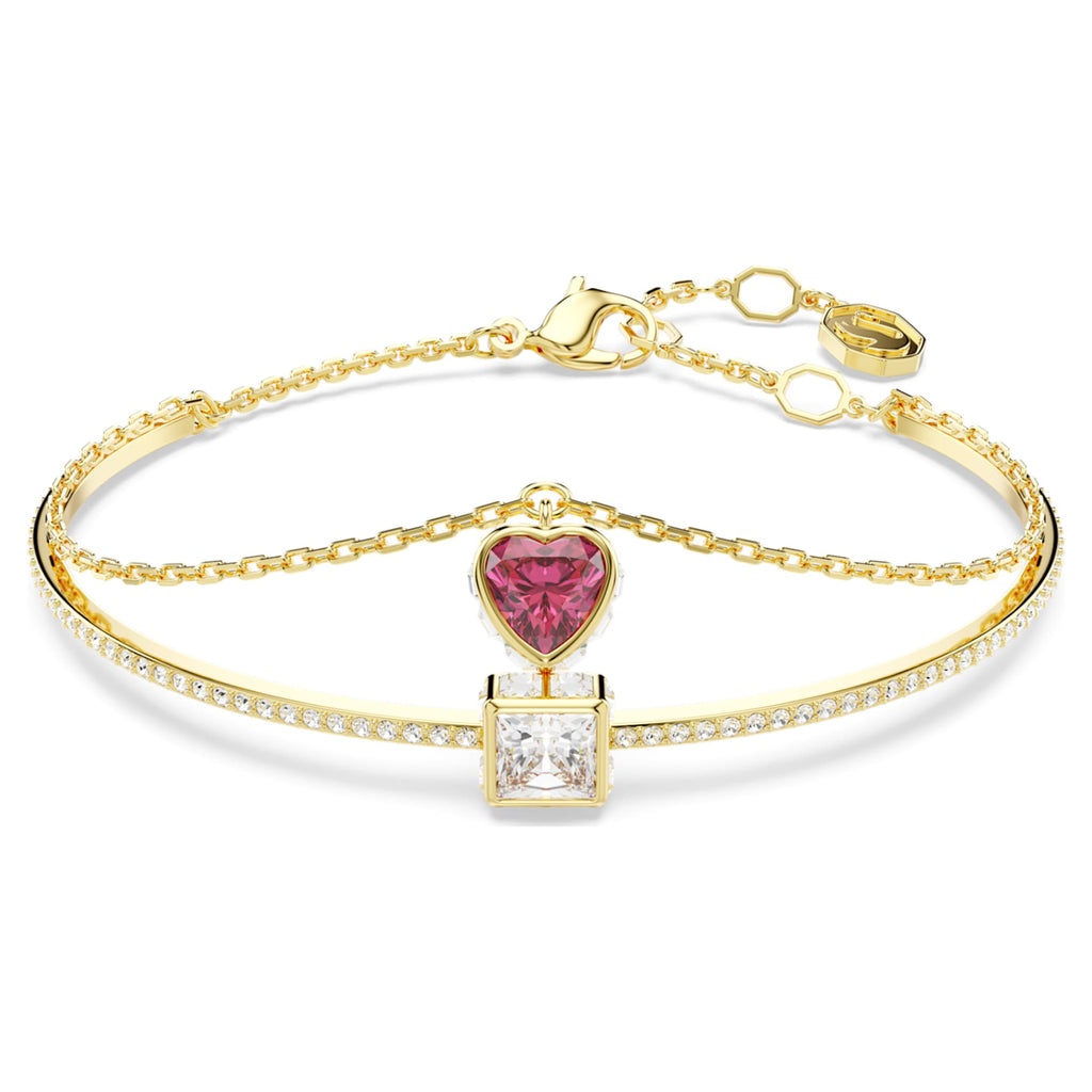 Swarovski Chroma bangle featuring a heart motif with red accents and an 18K gold finish