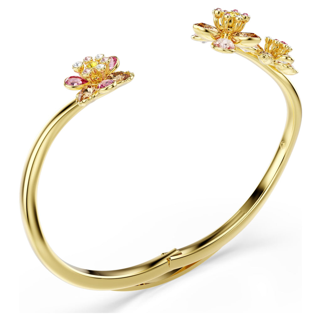 Swarovski Idyllia bangle featuring a flower motif with multicolored mixed-cut accents and an 18K gold finish