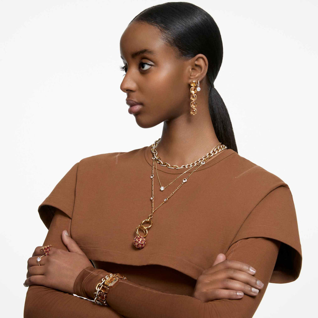 Swarovski Stilla drop earrings with white round-cut accents and an 18K gold finish